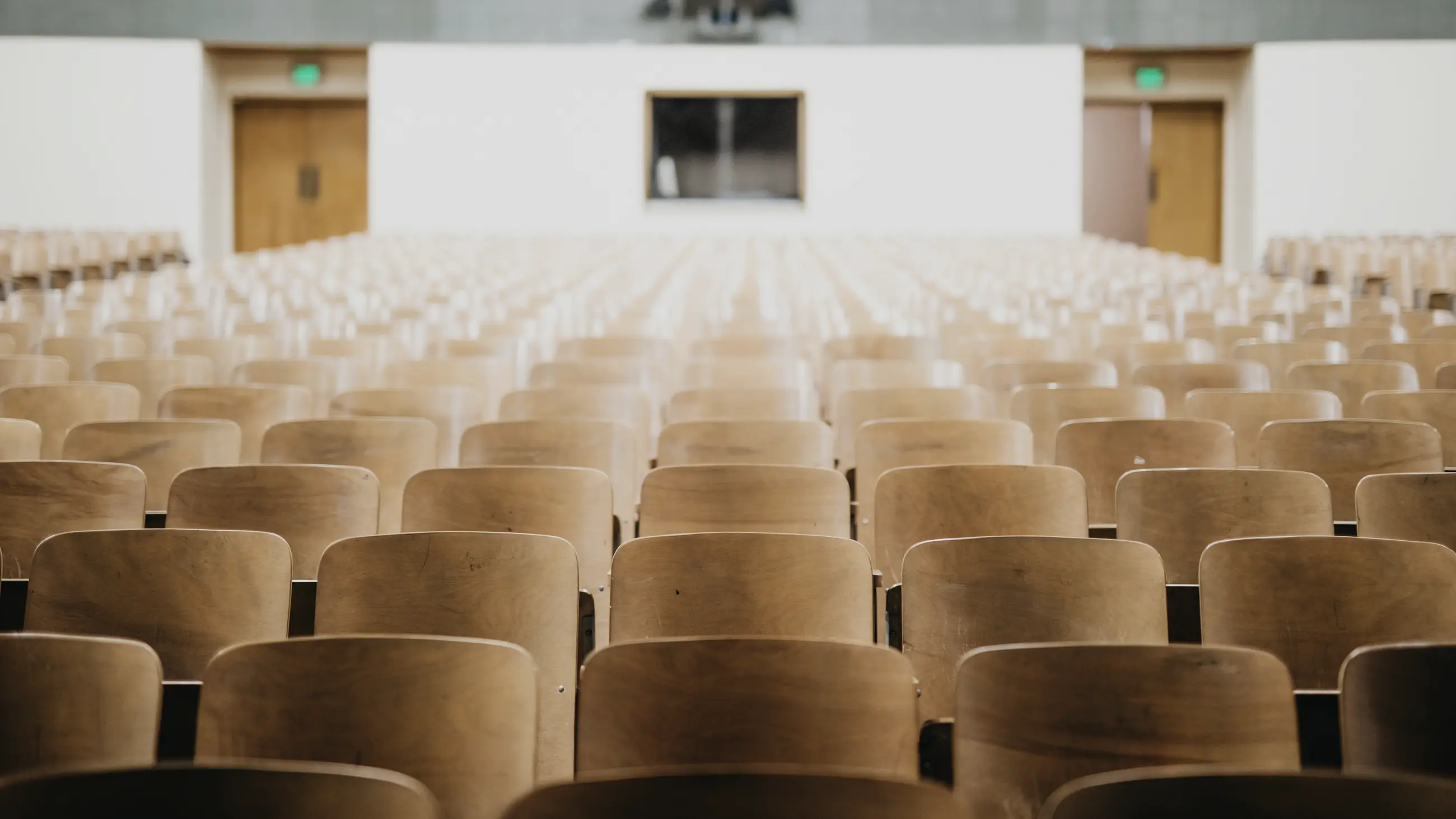 Empty seats in a university lecture hall.