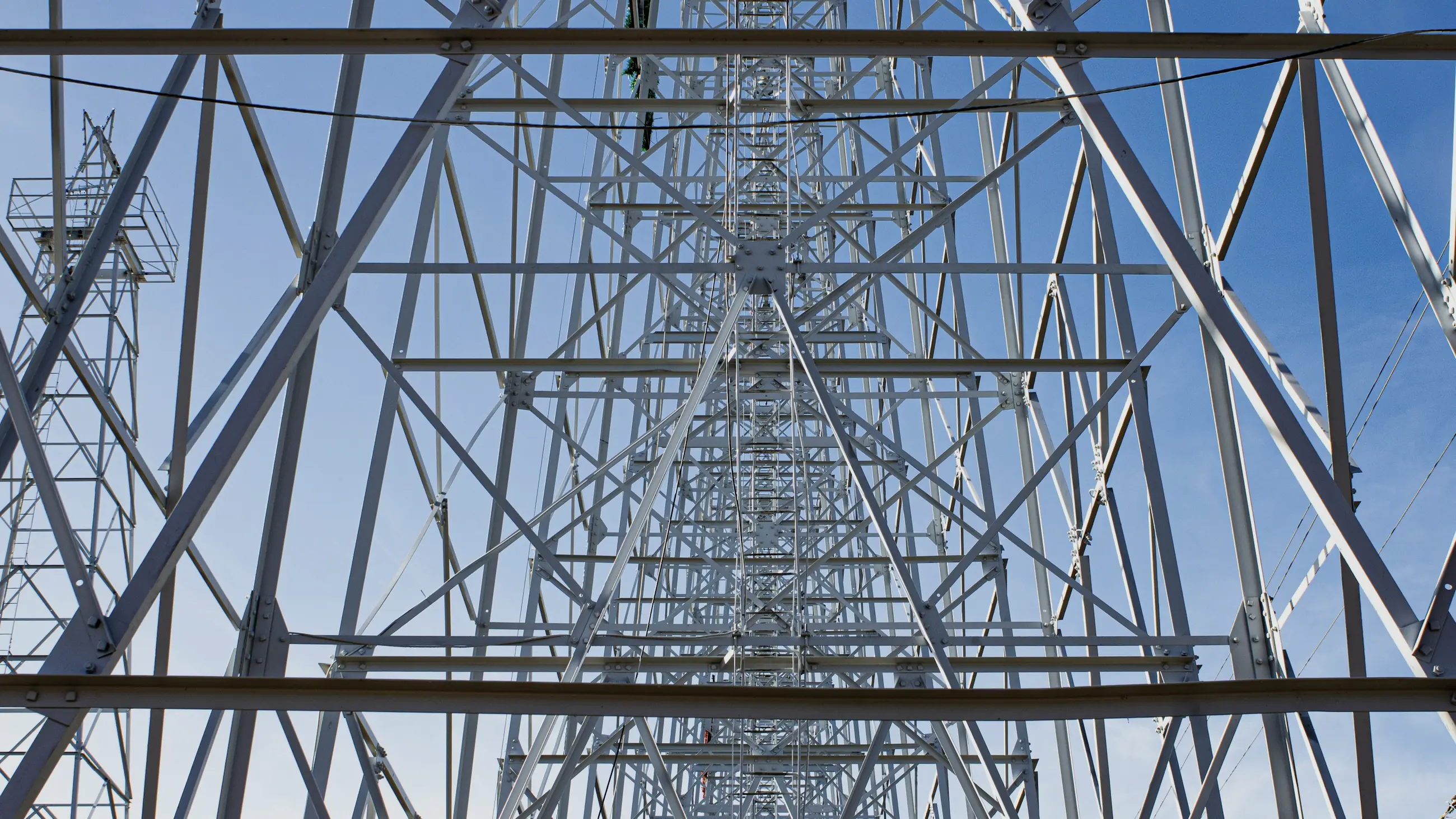 Looking up through a steel lattice tower.